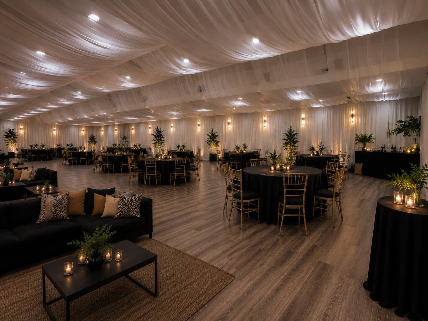 Candlelit private event reception with draped ceiling, lounge seating and round tables at Havenwing Vineyards
